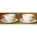 A Pair 19th Century Belleek Cups and Saucers on cream ground with pink handles (4)