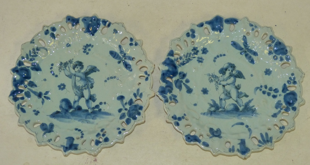 A Pair of Continental Blue and White Round Scalloped Delft Plates having pierced rim with cupids,