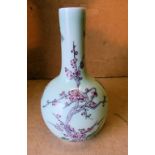 An Oriental Bulbous Thin Necked Vase on pale green ground with multicoloured branch,