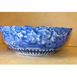 An Oriental Round Fruit Bowl having crinkled rim on blue and white ground with vase, floral,