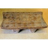 An African Rectangular Carved Wooden Stool/Headrest with parquetry top on 4 feet,