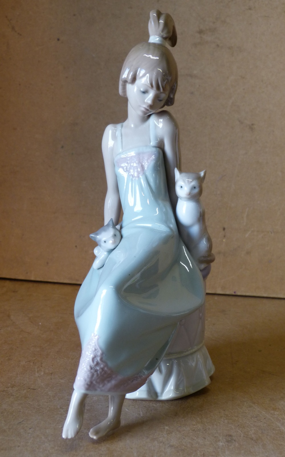 A Lladro Figure a young seated girl with cats,