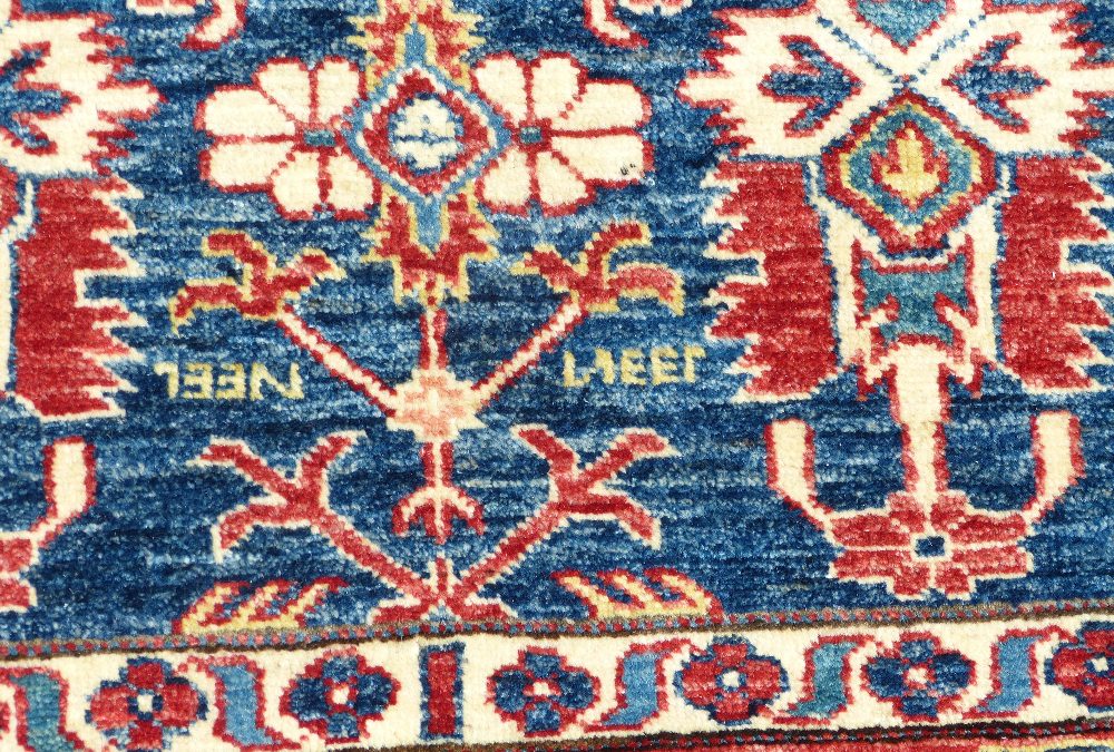 A Persian Rug on white, red and blue ground having various centre medallions, - Image 2 of 3