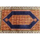 A Persian Rug on white, red and blue ground having centre medallion,