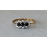 A 9ct Gold Ladies Ring set with 3 centre sapphires surrounded by clear stones