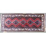 A Persian Runner on white, red and blue ground having 5 centre medallions,