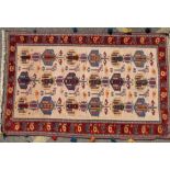 A Persian Rug on cream, red and blue ground,