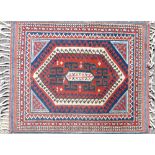 A Small Persian Rug on red and blue ground having centre medallions,