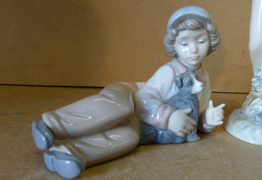 A Nao Figure of resting young boy holding  a puppy, 15. - Image 2 of 5