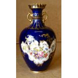 A Royal Crown Derby Bulbous Thin Necked 2-Handled Trumpet Shape Vase on Royal Blue ground with hand