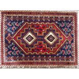 A Persian Rug on white, red and blue ground having 2 centre medallions with animal and bird motifs,