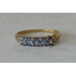 A 9ct Gold Ladies 5 Stone Ring set with pale blue stones