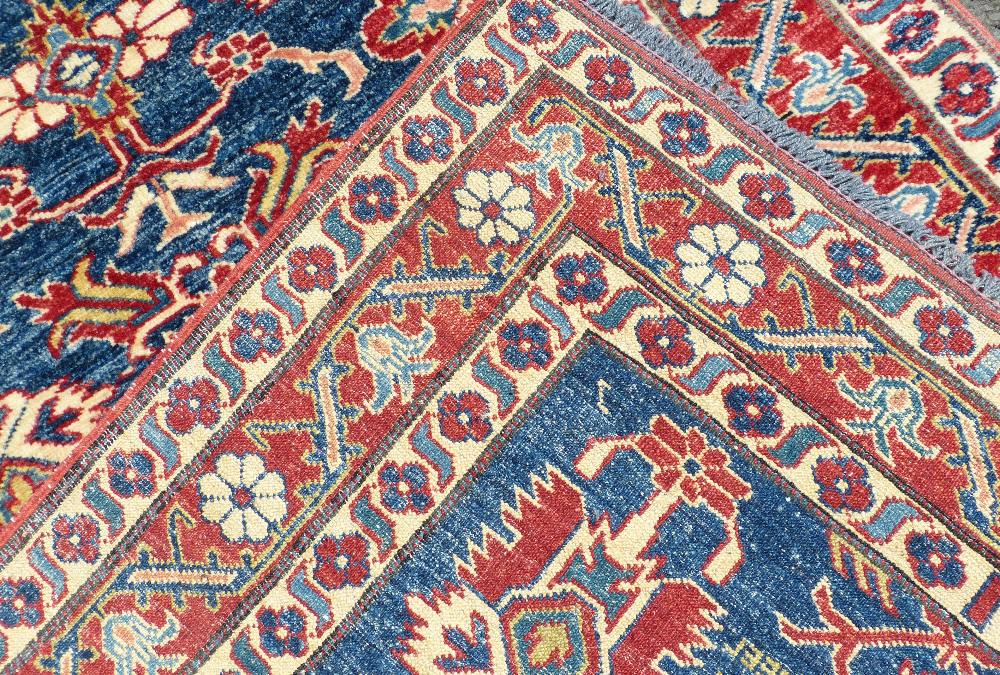A Persian Rug on white, red and blue ground having various centre medallions, - Image 3 of 3