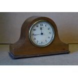 A Mahogany Small Arched Top Mantle Clock having cream dial with Arabic numerals on bun feet,