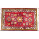 A Persian Rug on white, red and yellow ground having various centre medallions,