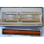 A Waterman's Fountain Pen on orange ground having 9ct gold mount,