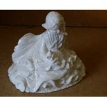 A China Figure of a seated girl holding a cat on white ground,
