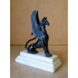 A Bronze Figure of  Seated Griffin on white marble platform base,