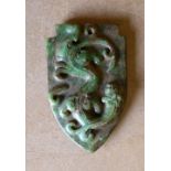 A Jade Style Shield Shape Pendant having raised dragon motif,