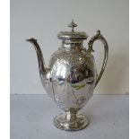 A Victorian Silver Bulbous Coffee Pot having allover embossed decoration, round sweeping base,