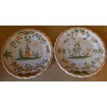 A Pair of Continental Delft Round Scalloped Plates on white, green and orange ground having figure,