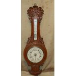 A Victorian Oak Banjo Barometer having carved shell, floral and scroll decoration,