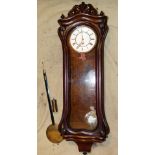 A Walnut Vienna Wall Clock with white enamel dial having Roman numerals,