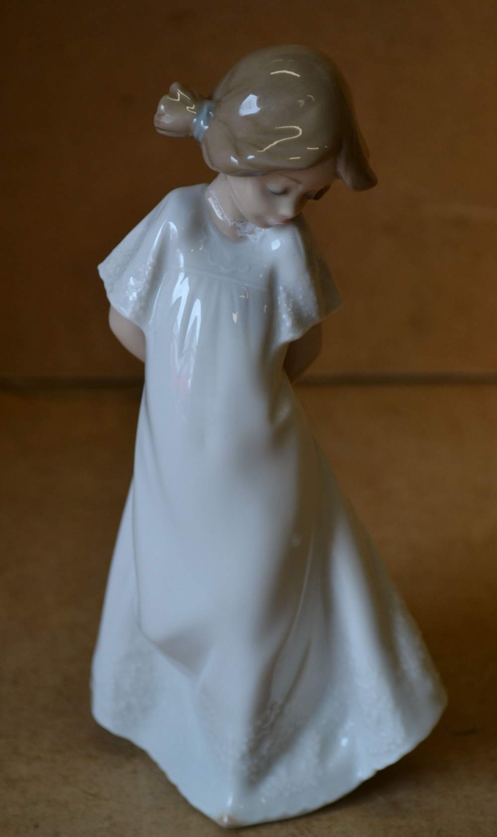 A Nao Figure of a young girl in nightdress (neck a/f)
