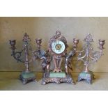 A Gilt Metal Clock Garniture having raised cupid motifs to clock,