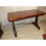 A 19th Century Mahogany Centre Table on shaped end supports, with bun feet and castors,