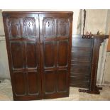 An Oak Double Wardrobe having 2 panelled doors with carved arched and floral decoration (no plinth)