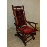 An American Walnut Rocking Chair having turned supports with over stuffed seat and part back