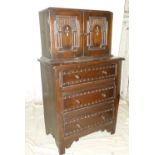 A Similar Oak Chest having 2 panelled doors with carved arched motifs above 3 long drawers with