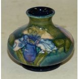 A Moorcroft Small Bulbous Thin Neck Trumpet Shape Vase on green and blue ground having