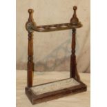 A Mahogany and Brass Umbrella Stand having turned supports,