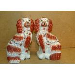 A Pair of 19th Century Staffordshire Seated Spaniels on white and red ground having gilt decoration,
