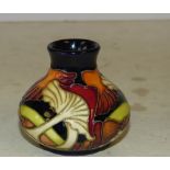 A Small Moorcroft Round Thin Neck Vase on blue ground with multicoloured mushroom and leaf