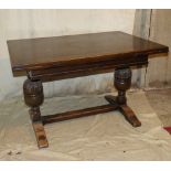 An Oak Draw Leaf Dining Table on 2 end bulbous supports having centre flat stretcher,