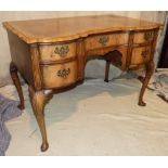 A Mahogany Serpentine Fronted Writing Desk having banded top,