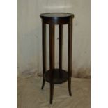 A Mahogany Round Torchere having inlaid stringing on square splayed legs,