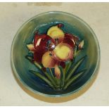 A Moorcroft Small Round Bowl on green and blue ground having multicoloured floral and leaf