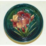 A Moorcroft Small Round Bowl on green ground having multicoloured floral and leaf decoration, 11.