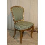 A 19th Century Gilt Spoon Back Single Chair having green striped overstuffed seat and back  on