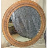 A Large Circular Hanging Wall Mirror having raised leaf and ball rim,