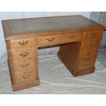 A Victorian Oak Kneehole Double Pedestal Desk having green leather inset top,