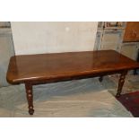 A Heavy French Elm and Oak Kitchen Table having triple planked top on round turned legs,