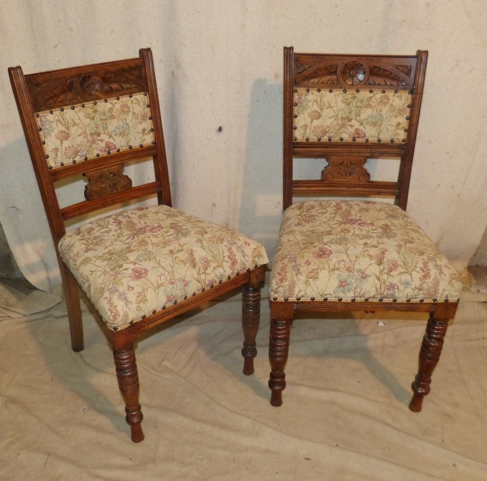 A Set of 4 Oak Single Chairs having carved floral and leaf decoration,