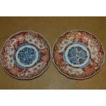 A Pair of Imari Round Scalloped Plates on white, red and blue ground having all over bird, floral,