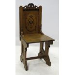 An oak Gothic revival chair, with ebonis