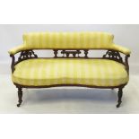 An Edwardian serpentine sofa, with pierc